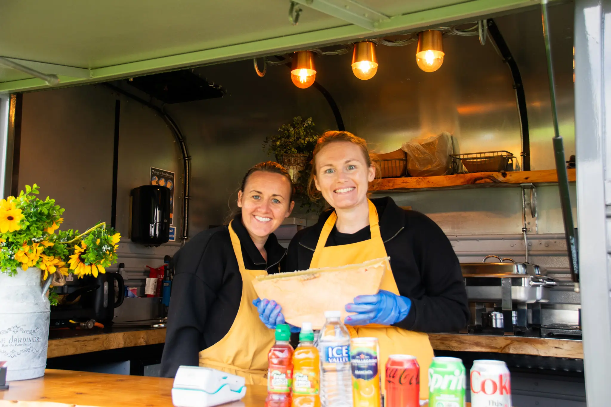 Two women smiling in a food truck