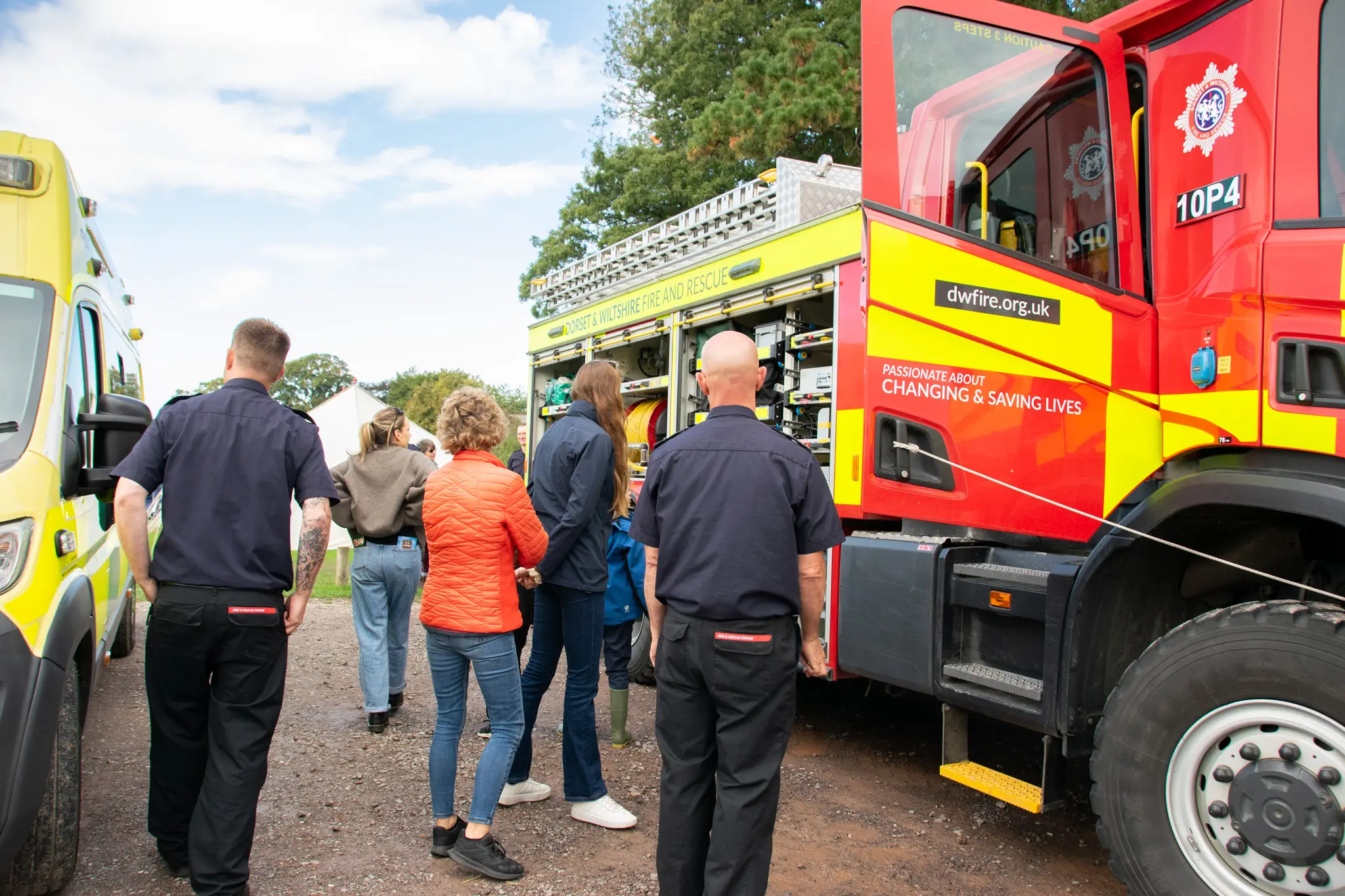 Firefighters and visitors near emergency vehicles