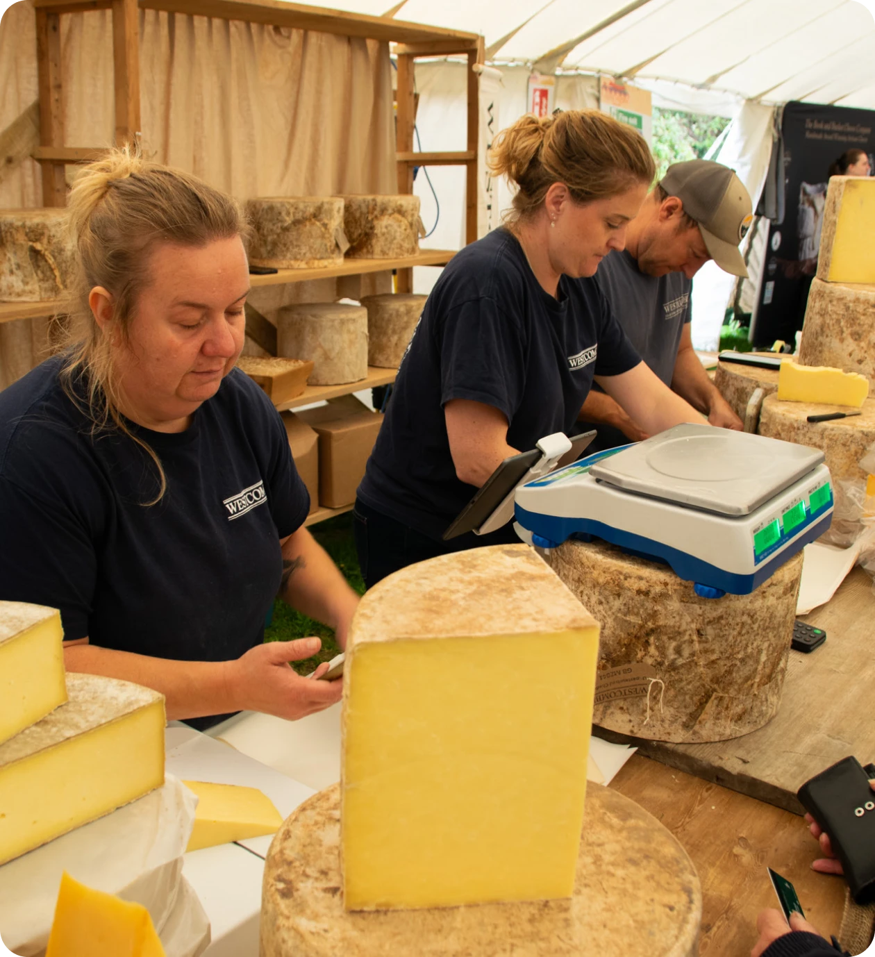 Workers slicing cheese at a festival