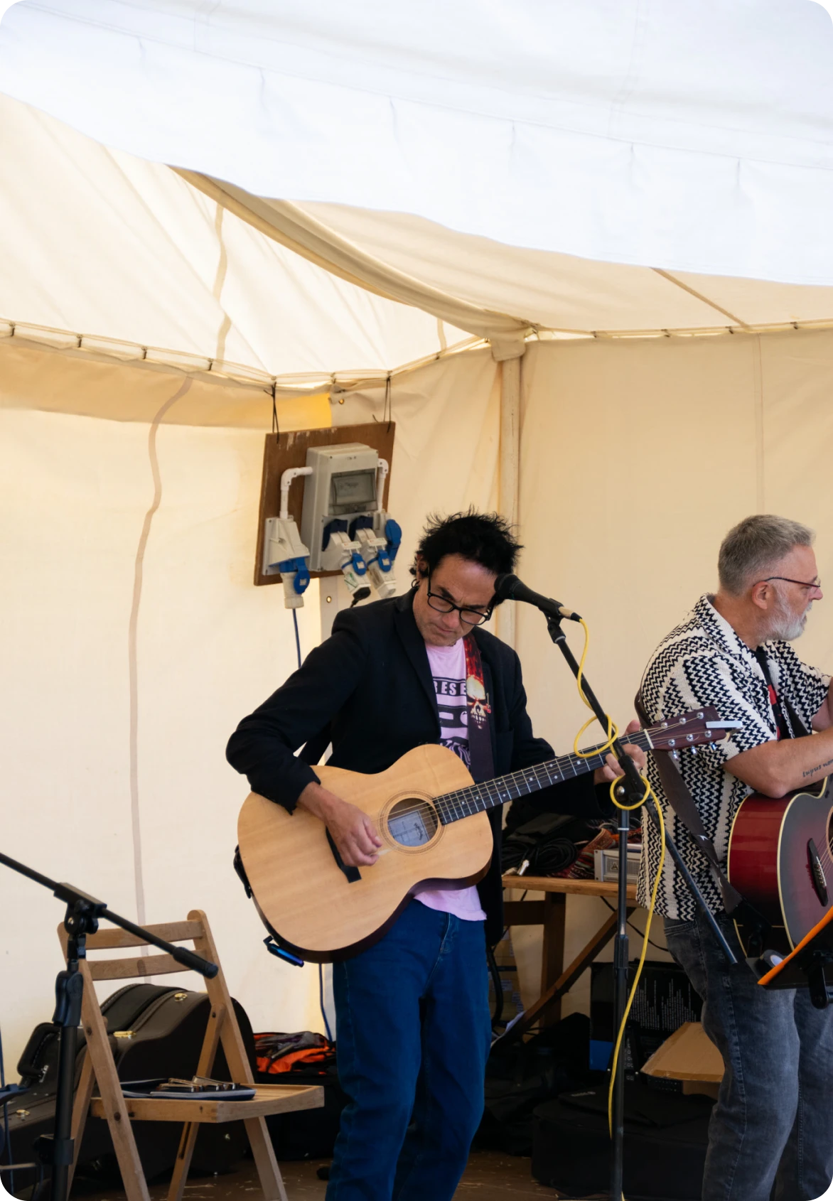 Two guitarists performing together on stage