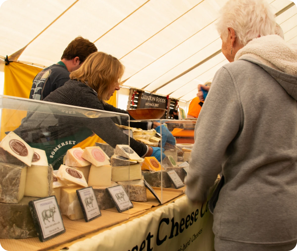 Cheese vendors serving customers indoors